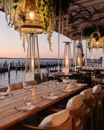 EHP Resort restaurant deck at sunset with waterfront views