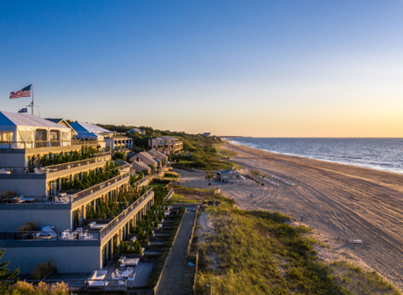Gurney’s Montauk Resort at sunset with beach and lush greenery