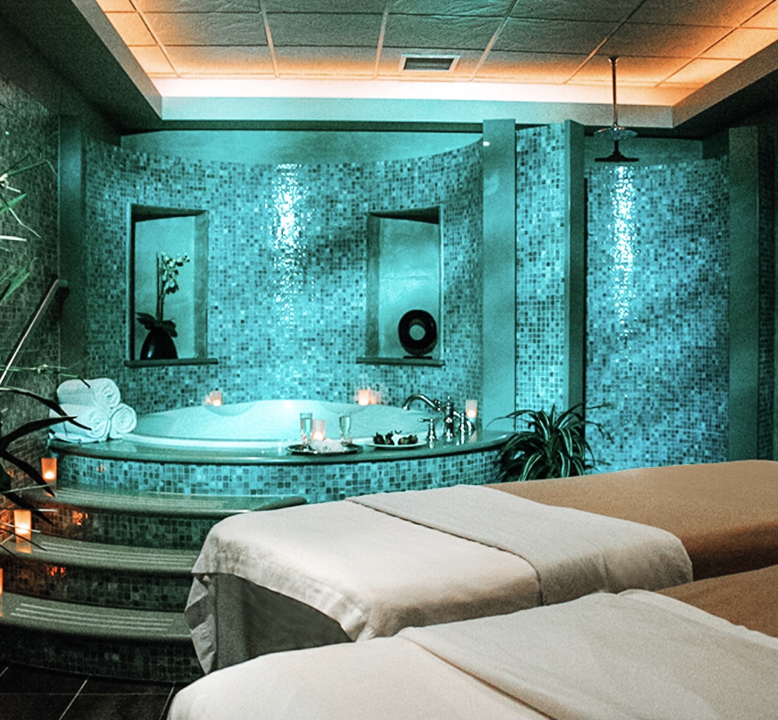 East Wind Spa turquoise room with massage tables and jacuzzi