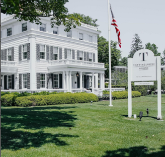 Topping Rose House hotel, three-story white building surrounded by green landscaping