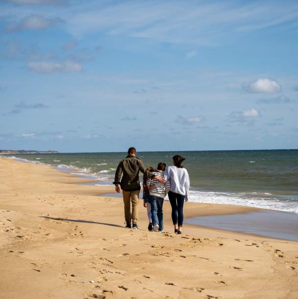 Family walking along beach