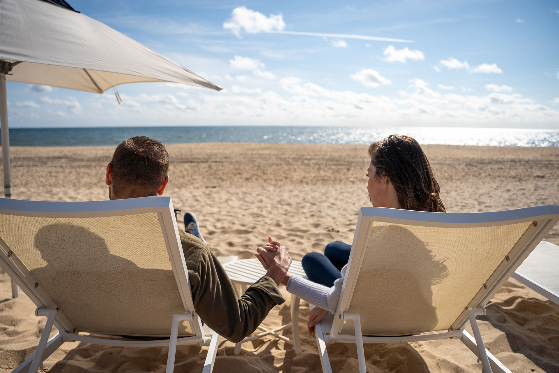 Couple relaxing in beach chairs at Gurney's Montauk Resort, Long Island