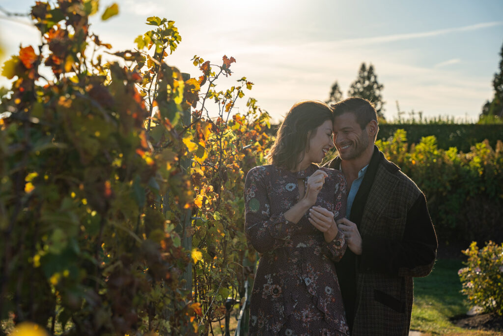 Couple toasting wine at Wolffer Estate Vineyard at sunset, Long Island