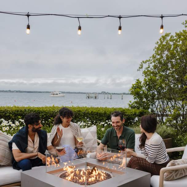 Friends enjoying an evening by the fire on Long Island