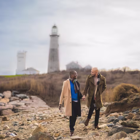 two men holding hands in coastal cold weather