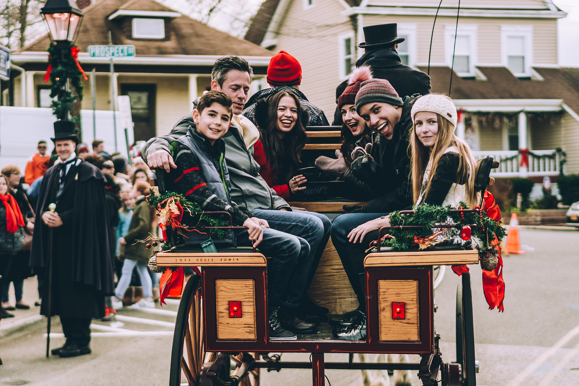 Carolers in Victorian dress on a horse-drawn carriage at the Charles Dickens Festival, Long Island