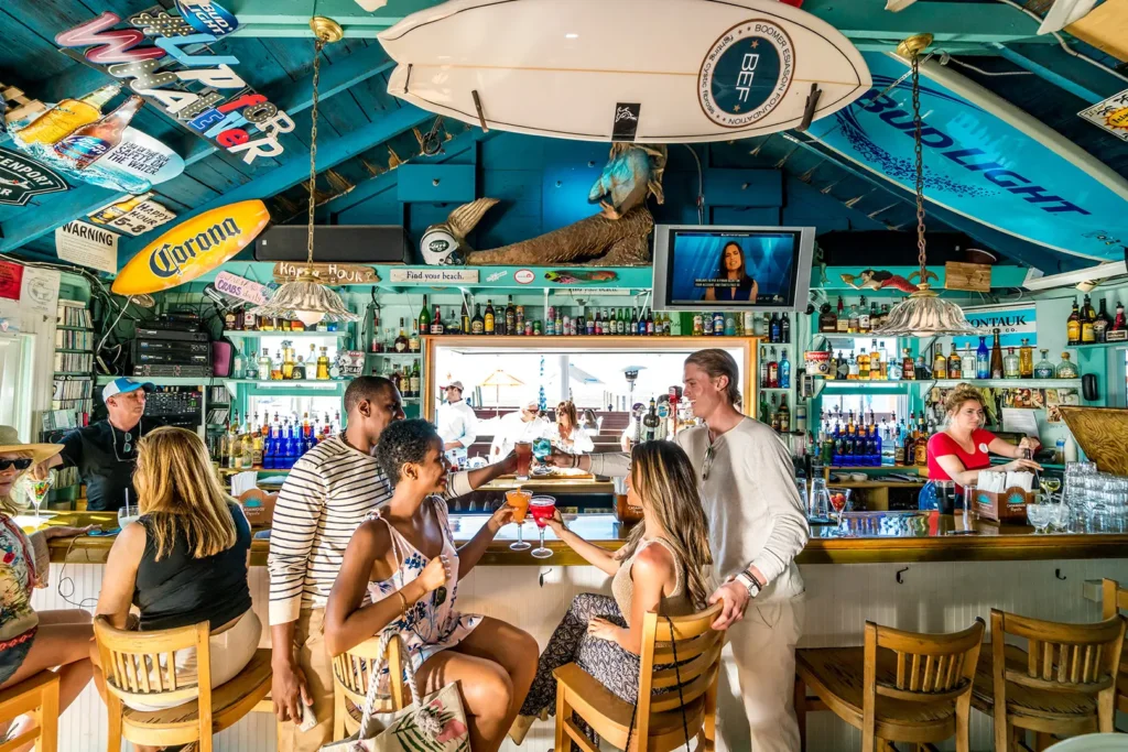 Bartenders serving guests at a bar on Fire Island, Long Island