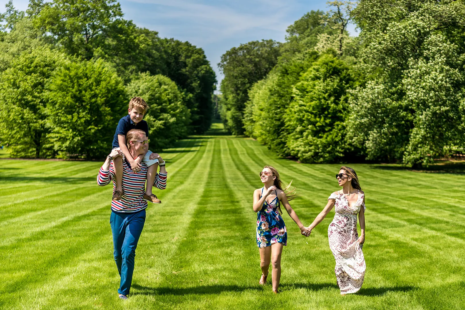 Family strolling through the manicured lawns of Old Westbury Gardens on Long Island