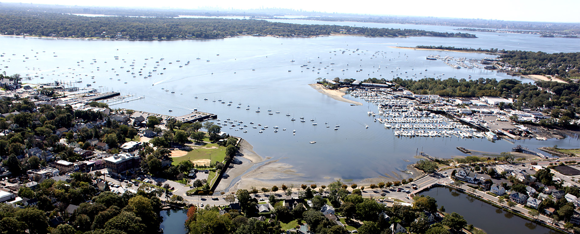 Aerial view of a Long Island harbor town and marina