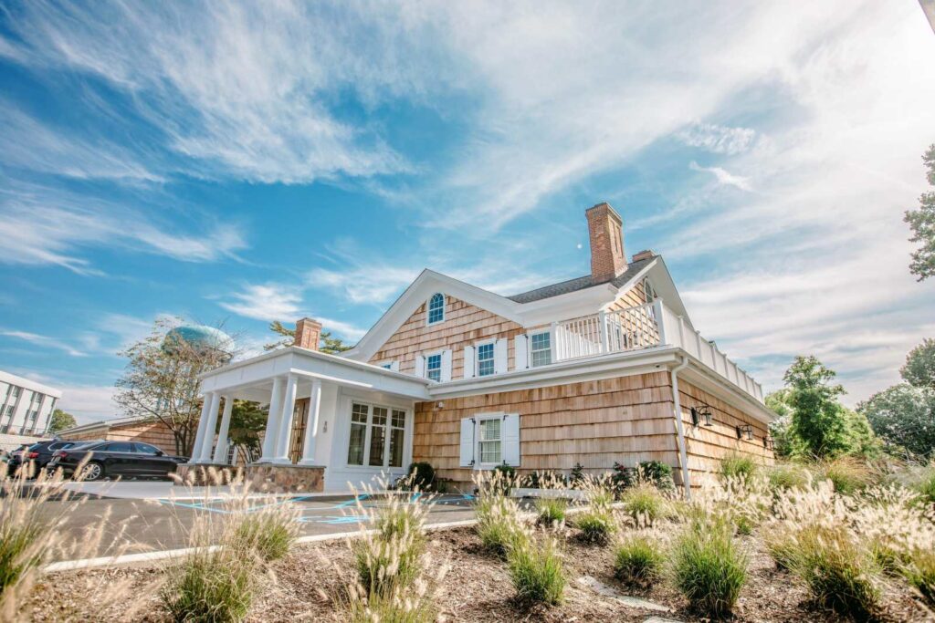Image of The Opus Steakhouse, which is a beige building in the style of a coastal home