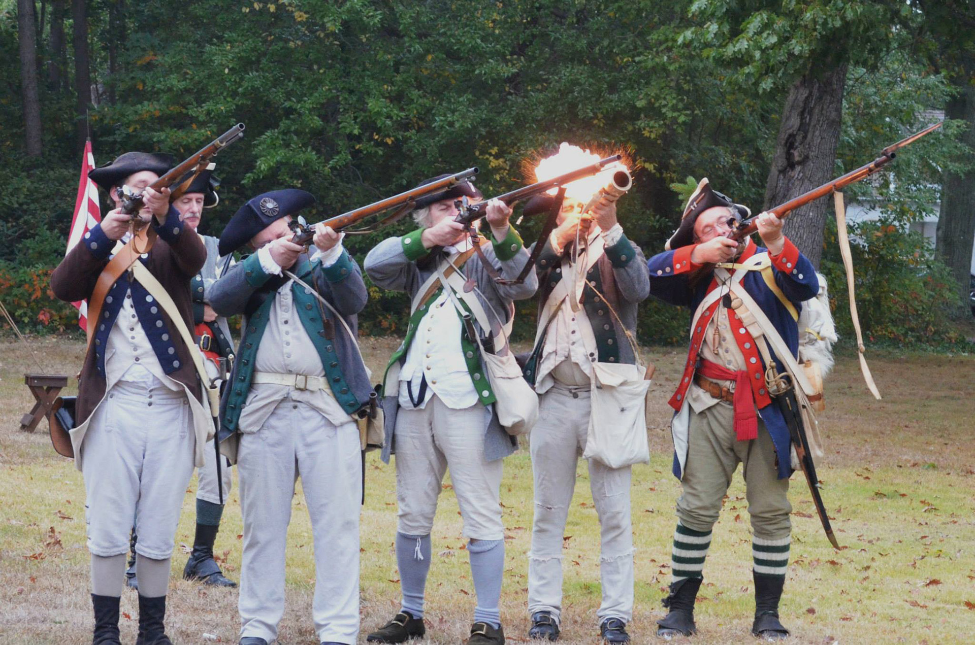 Revolutionary War reenactors firing muskets on Long Island's North Shore