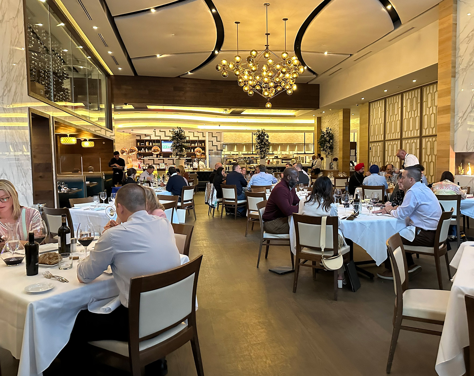 Elegant white-tablecloth dining room at an upscale Long Island restaurant