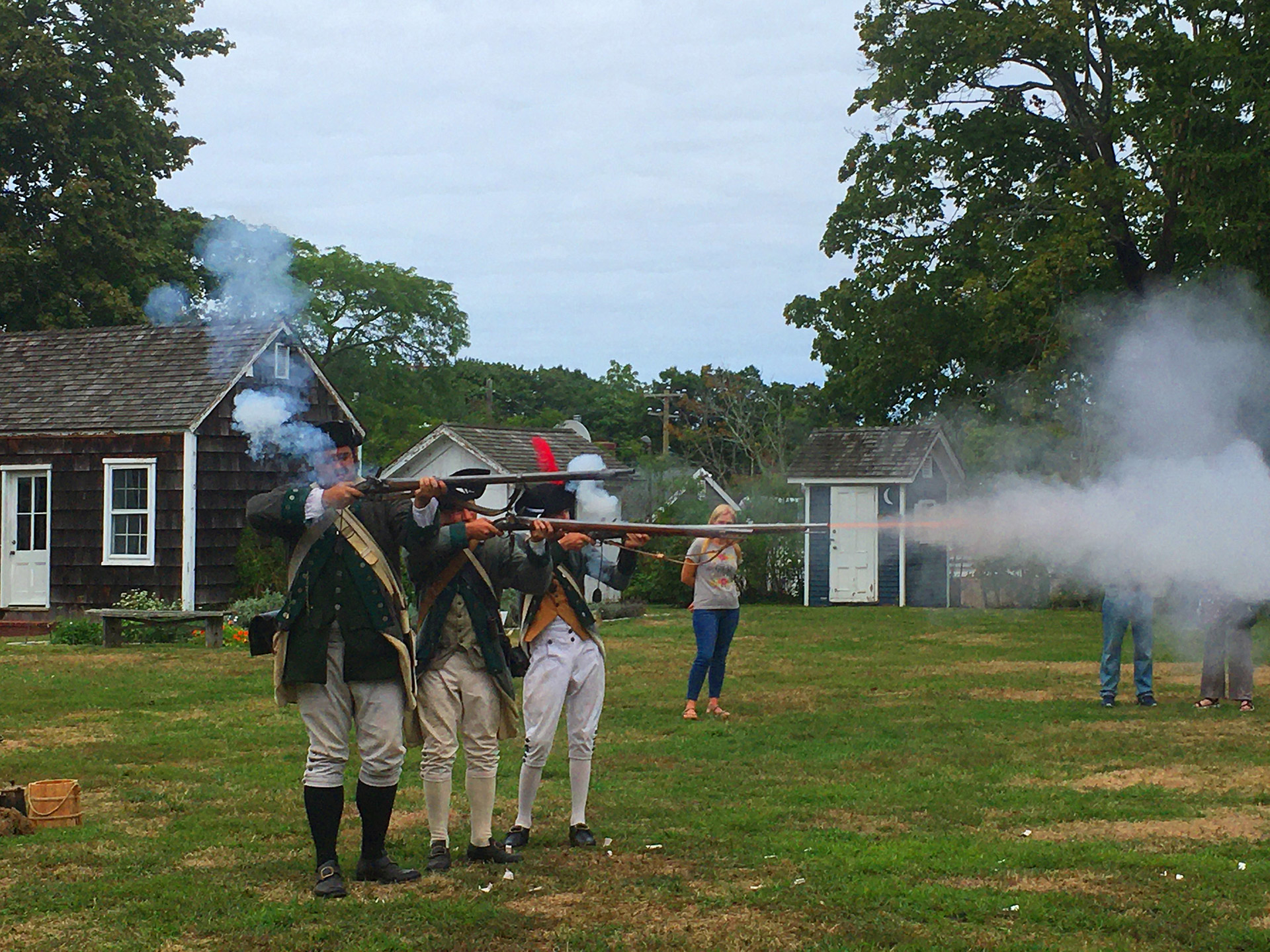 Revolutionary War reenactors firing muskets at Southold Historical Museum, Long Island