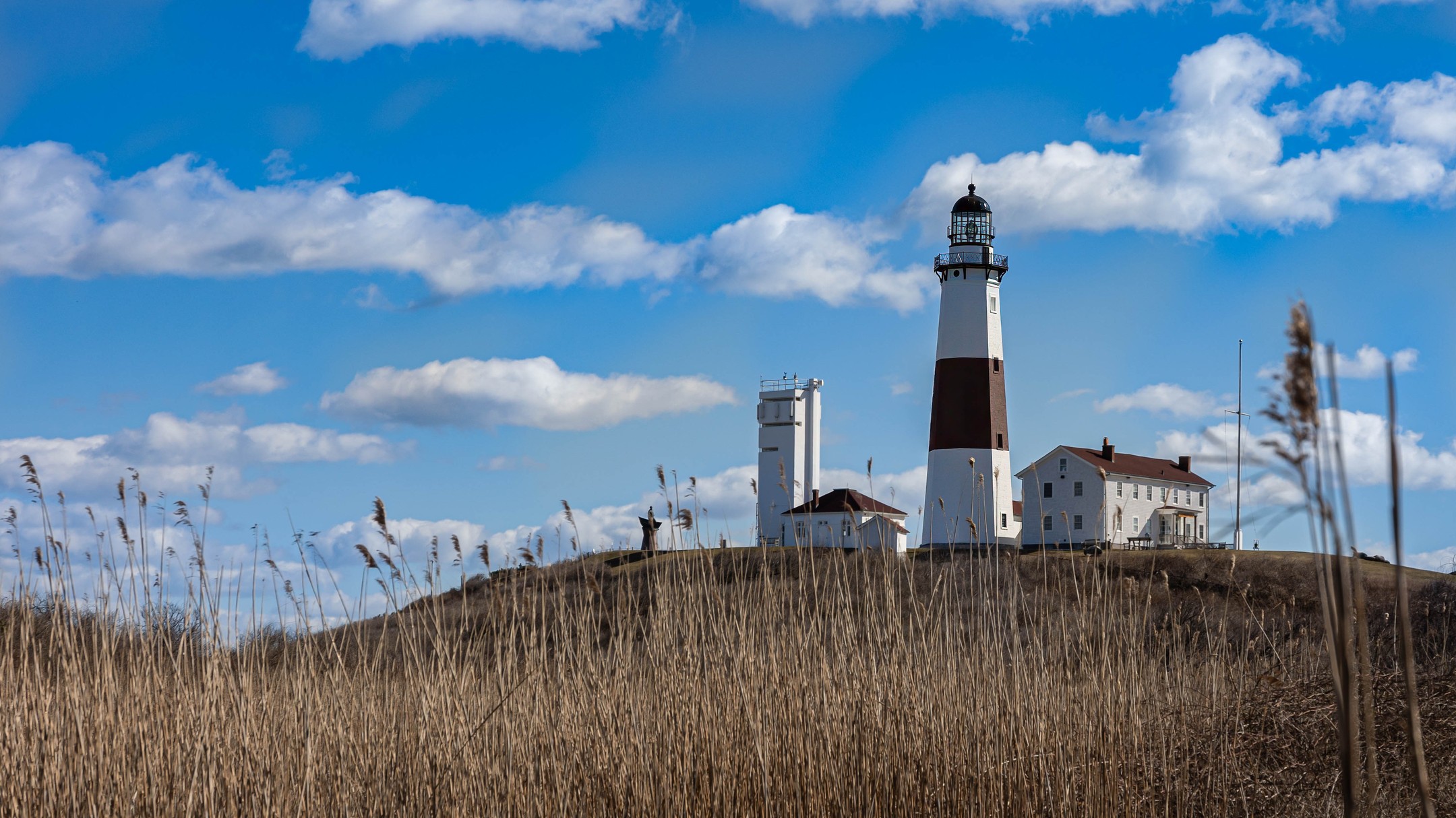 Montauk Point Lighthouse rising above coastal grasses on Long Island