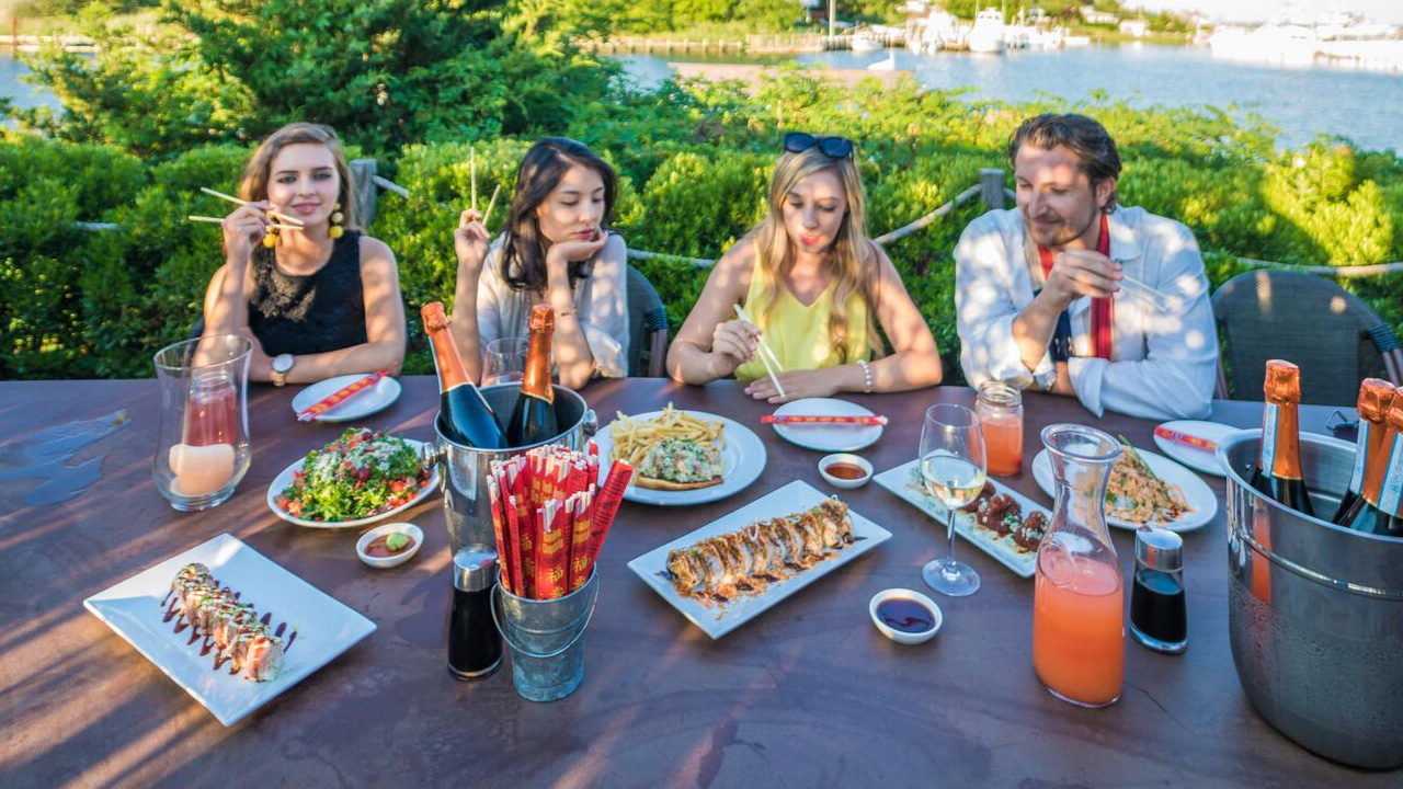 Friends enjoying an outdoor dinner in Montauk, Long Island