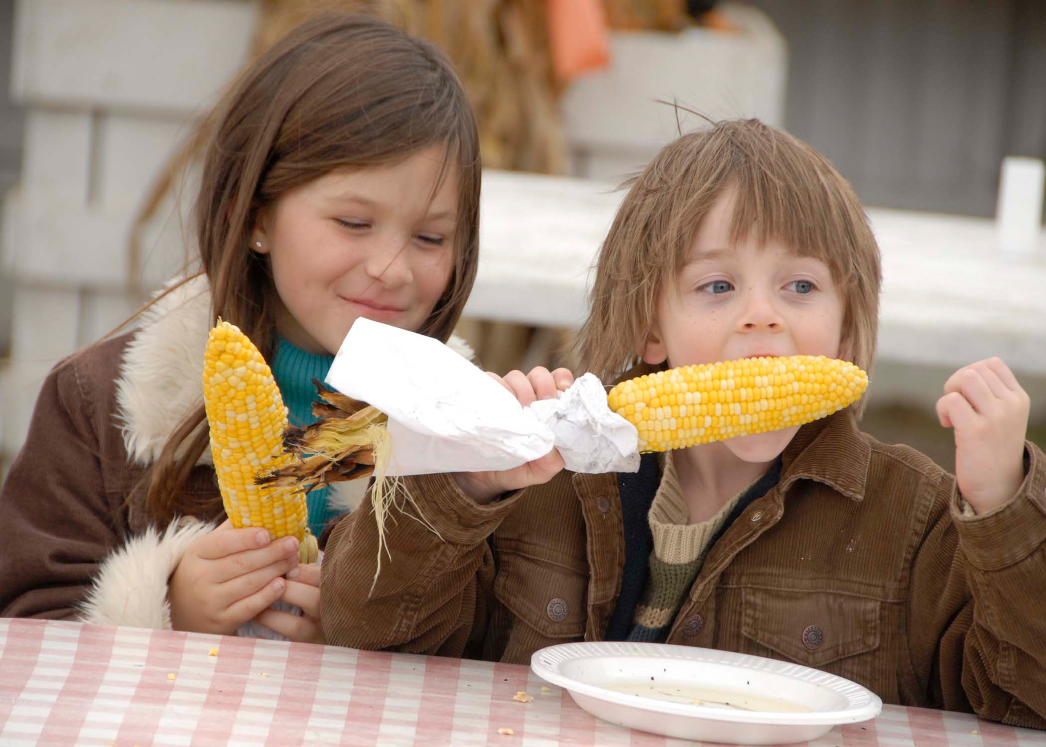 Children enjoying corn on the cob at a Long Island restaurant