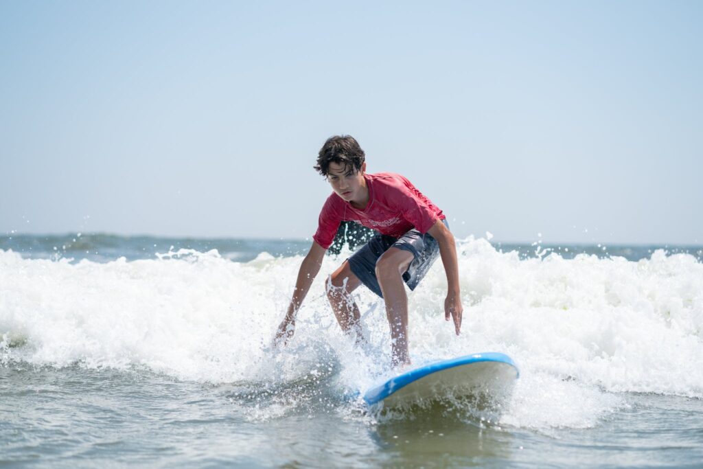 Surfer riding a wave on a Long Island beach